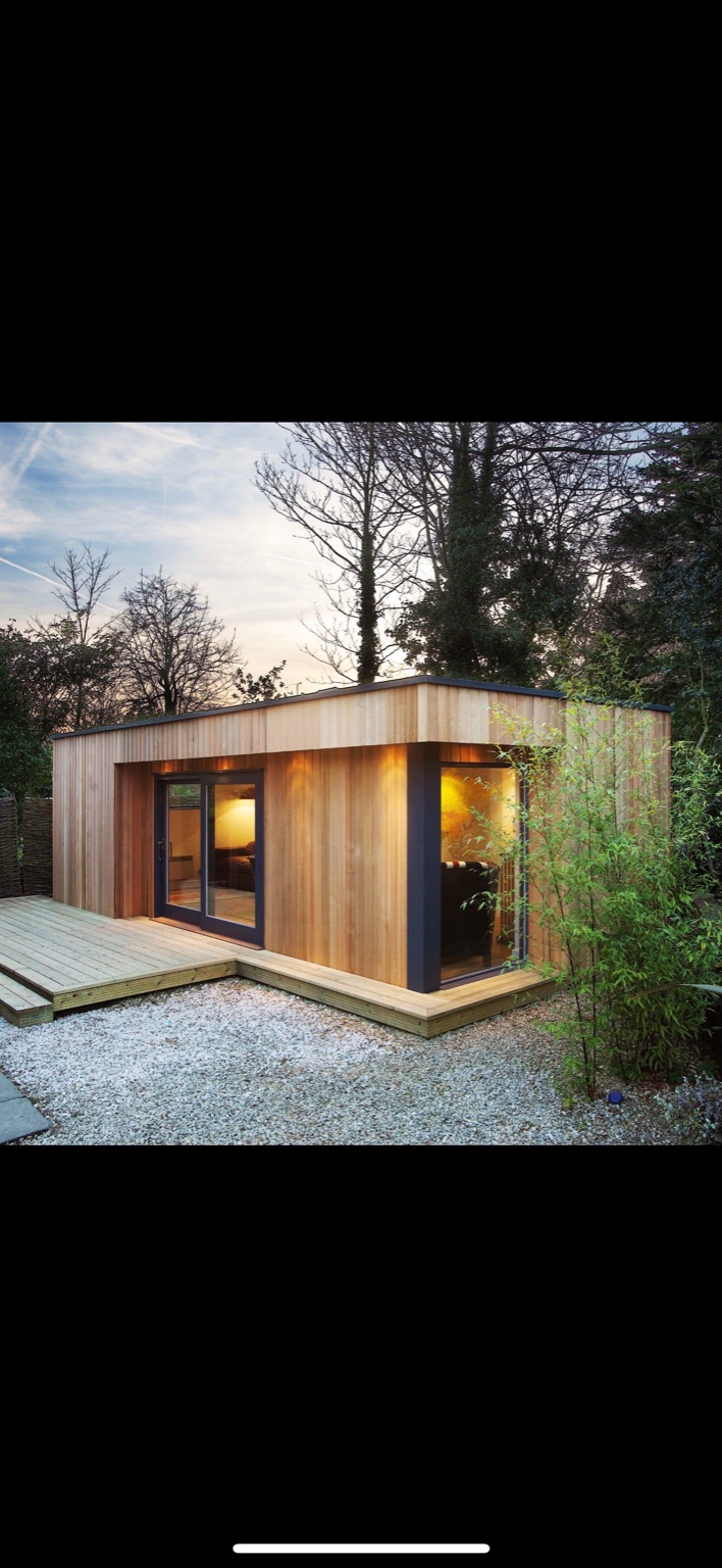 Cedar-clad garden room at dusk